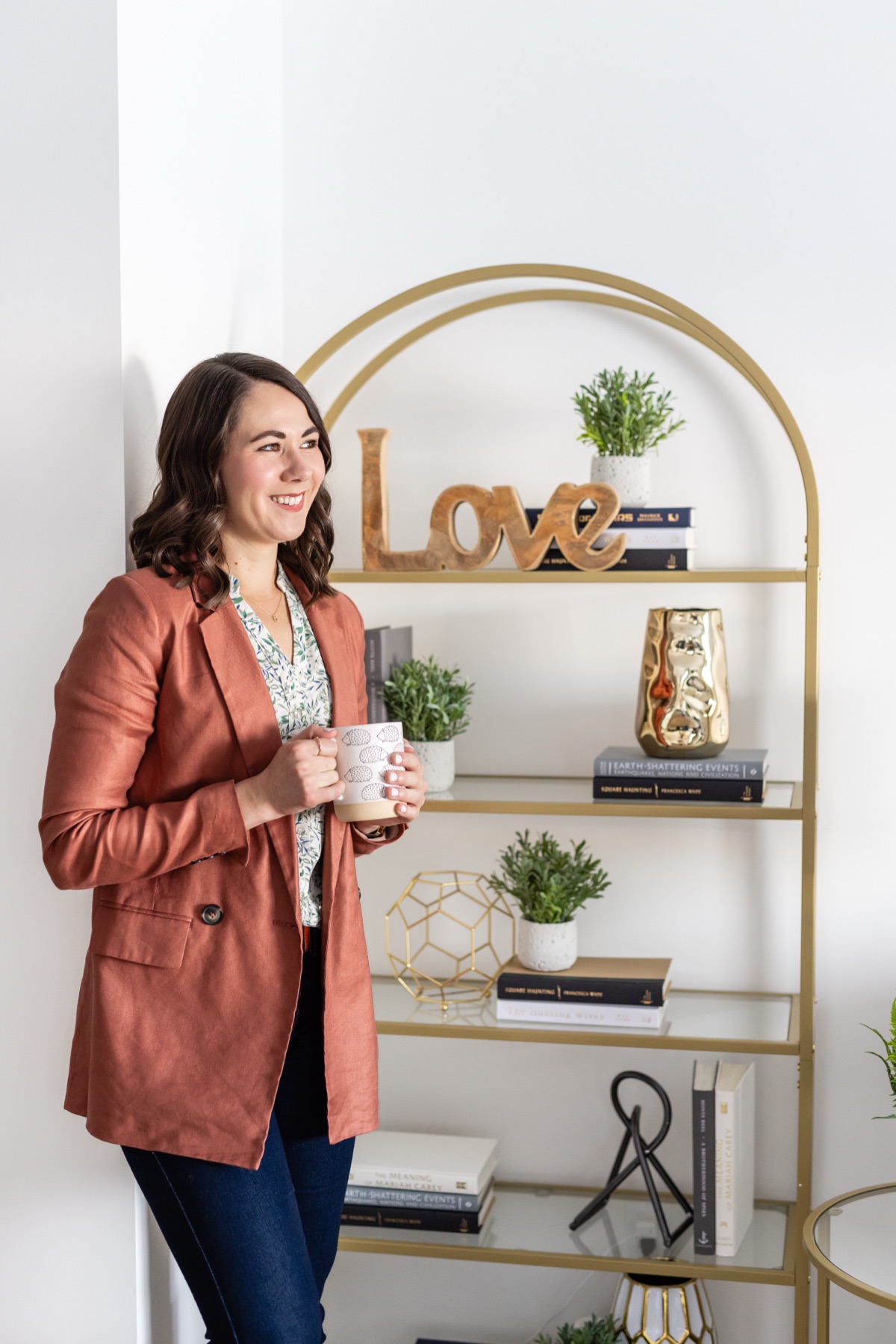 Brittany with coffee by bookshelf