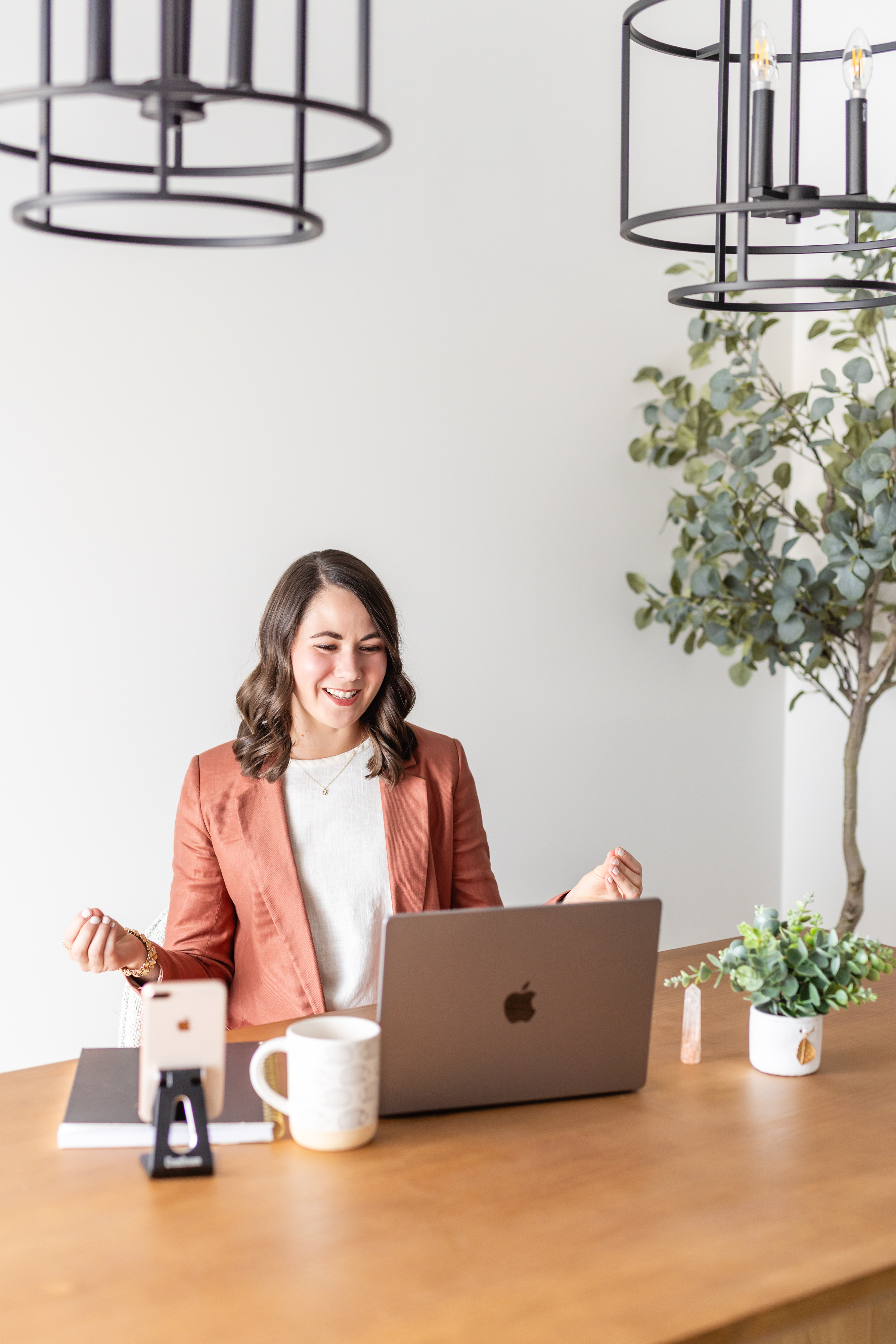Brittany at her desk, excited fist pump celebrating a result